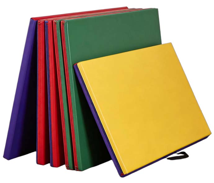 Colorful folding gymnastics mats in purple, red, green and yellow with smooth vinyl covers, leaning upright in a row