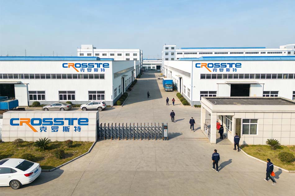 Crosste factory gate and white production buildings with the Crosste logo on the rooftops
